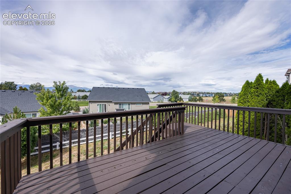 Image 29 of 34: Expansive outdoor deck with wood-finish railing and decking, offering dista