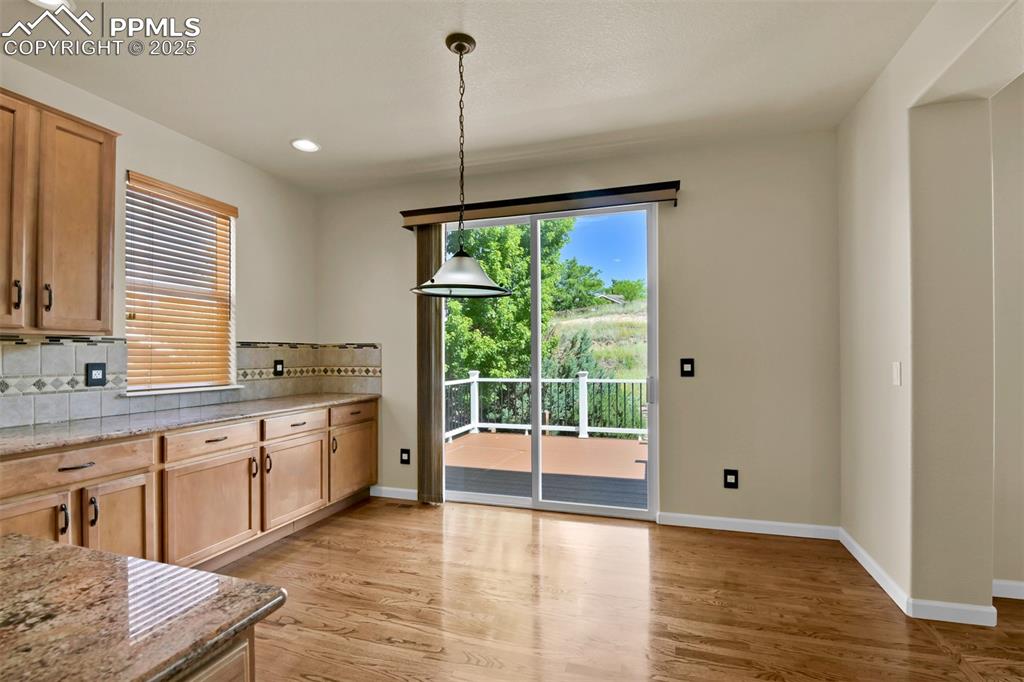 Image 17 of 50: Kitchen with decorative backsplash, light wood-style flooring, recessed lig