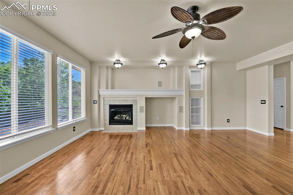 Image 19 of 50: Unfurnished living room featuring light wood-style floors, a fireplace, cei