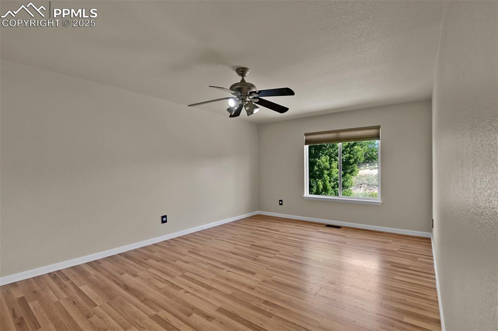 Image 36 of 50: Spare room with a ceiling fan and light wood finished floors