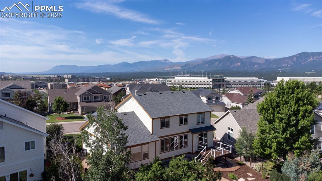 Image 4 of 50: Aerial view of residential area featuring a mountainous background