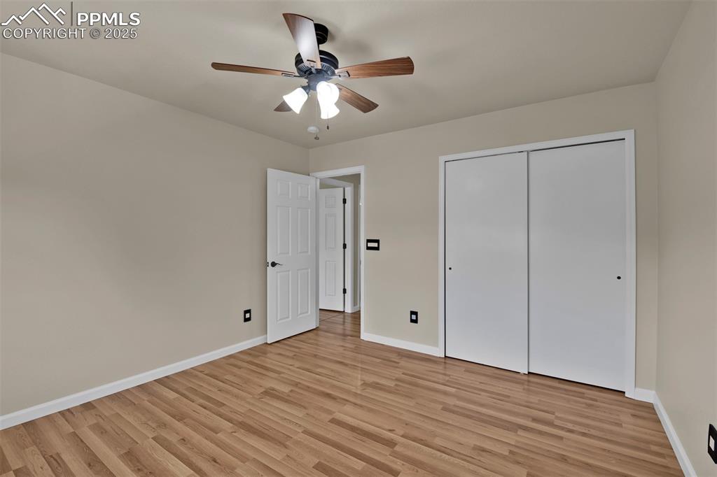 Image 43 of 50: Unfurnished bedroom featuring light wood finished floors, a ceiling fan, an