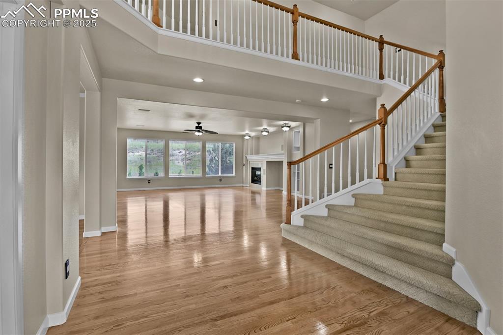 Image 9 of 50: Entrance foyer with a towering ceiling, wood finished floors, recessed ligh