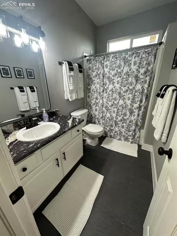 Image 16 of 23: Bathroom with vanity and a shower with shower curtain
