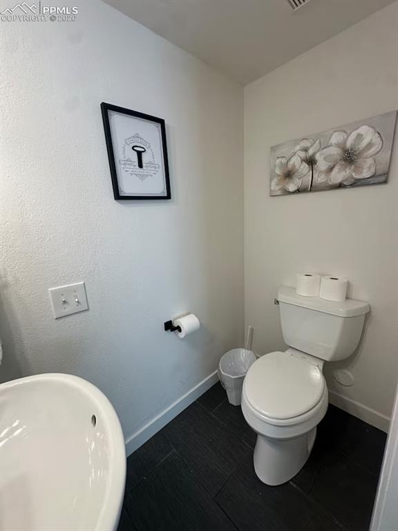 Image 18 of 23: Bathroom with toilet and baseboards
