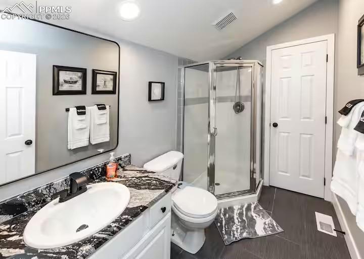 Image 22 of 23: Full bath with vanity, a shower stall, and lofted ceiling