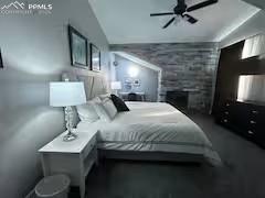 Image 5 of 10: Bedroom featuring a ceiling fan and vaulted ceiling