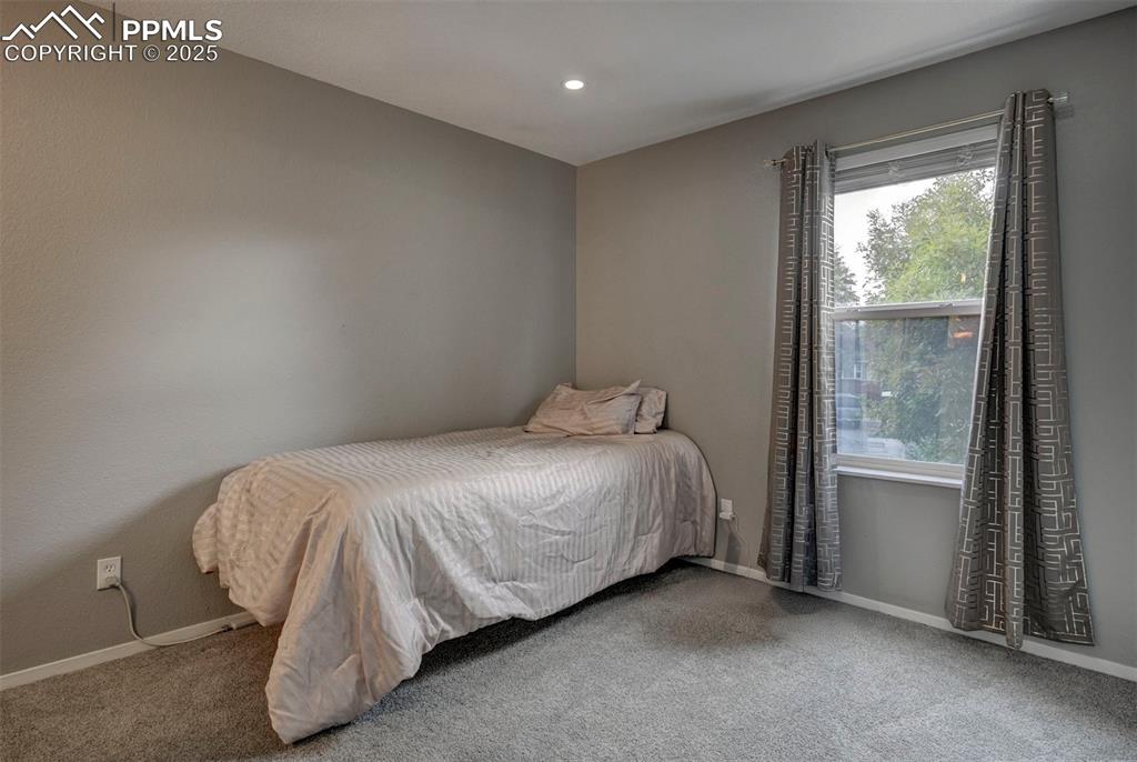Image 17 of 33: Bedroom with carpet flooring and recessed lighting