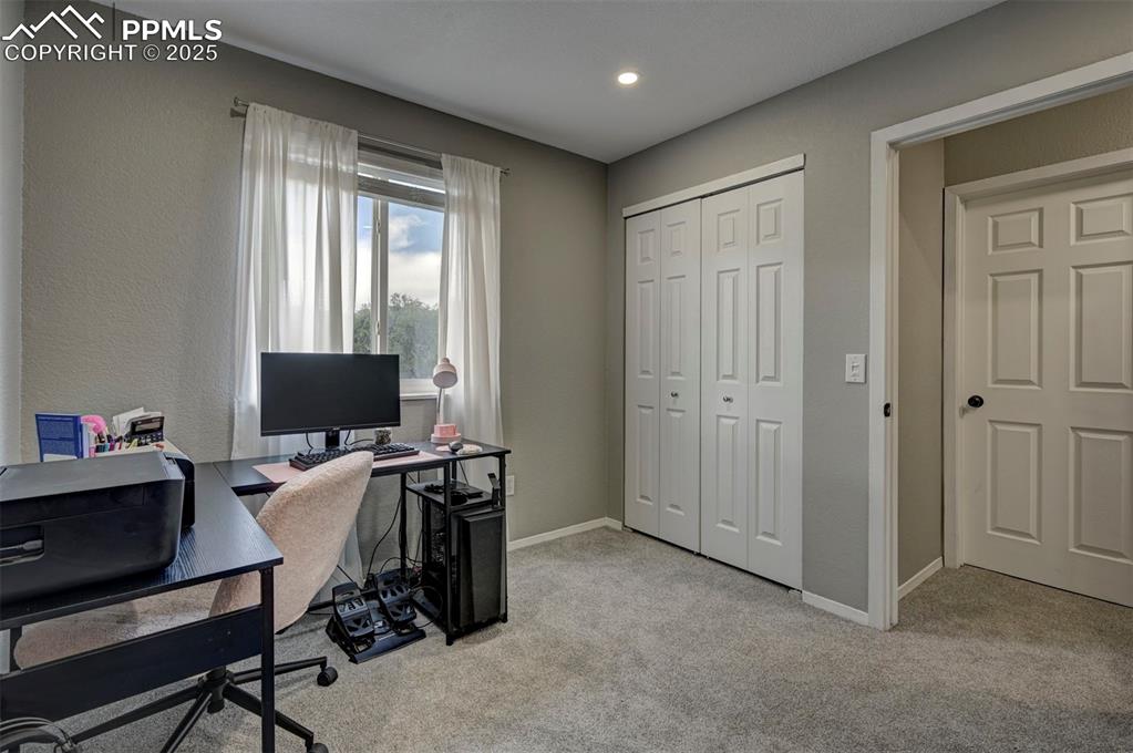 Image 20 of 33: Office area featuring light carpet and baseboards