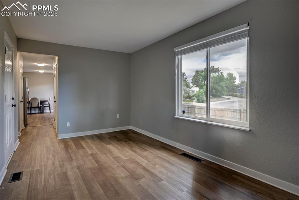 Image 23 of 33: Spare room featuring wood finished floors