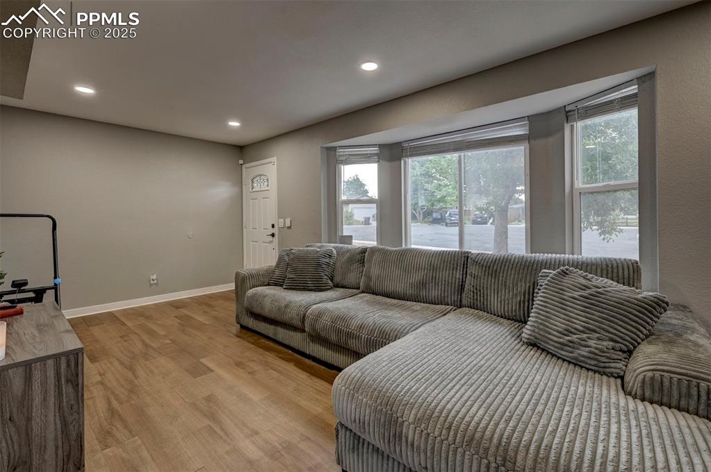 Image 24 of 33: Living area with plenty of natural light, light wood-style floors, and rece