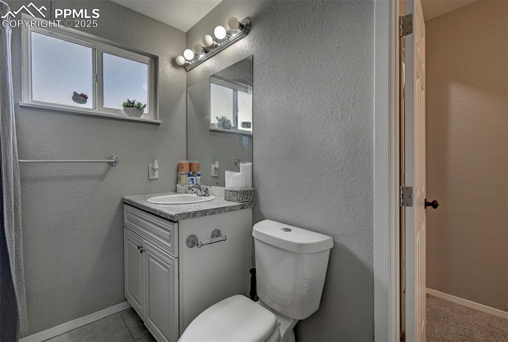 Image 6 of 33: Bathroom featuring vanity and a textured wall
