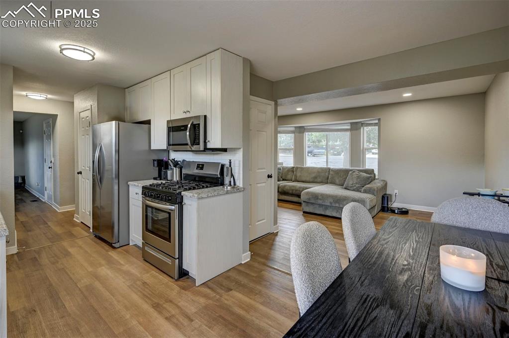 Image 7 of 33: Kitchen featuring appliances with stainless steel finishes, open floor plan