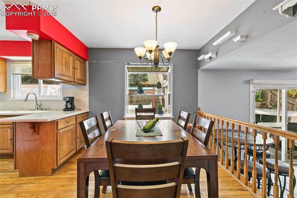 Image 16 of 36: Dining space featuring a chandelier and light wood finished floors