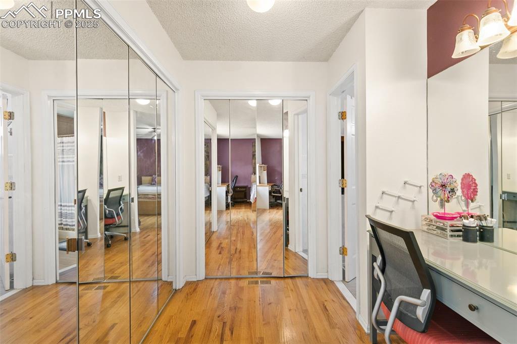 Image 23 of 36: Home office with light wood-style flooring and a textured ceiling