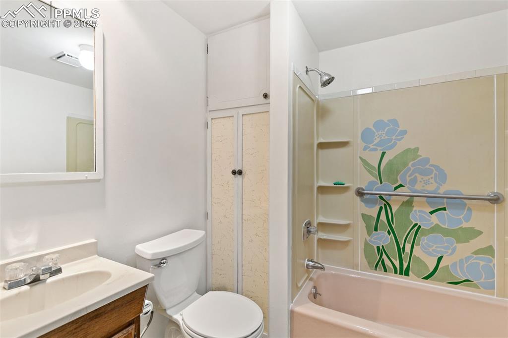 Image 32 of 36: Full bath with shower / tub combination and vanity