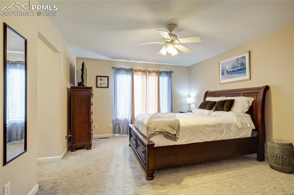 Image 16 of 42: Bedroom featuring light colored carpet and ceiling fan