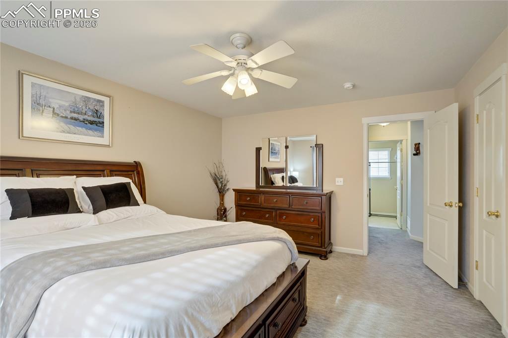 Image 18 of 42: Bedroom with light carpet and ceiling fan