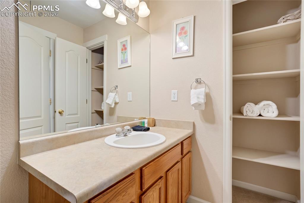 Image 31 of 42: Bathroom with vanity and a spacious closet