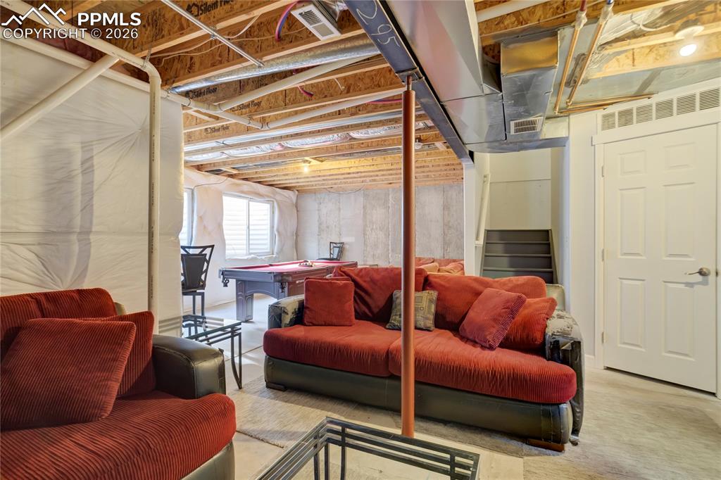 Image 34 of 42: Basement with billiards and stairway