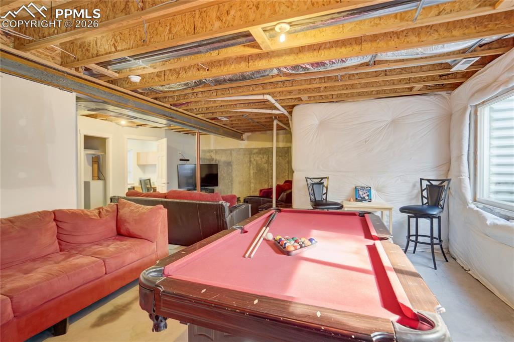 Image 36 of 42: Game room featuring billiards table and concrete floors