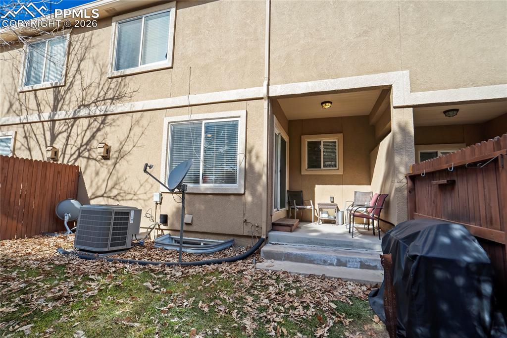 Image 41 of 42: Rear view of property featuring stucco siding and a patio