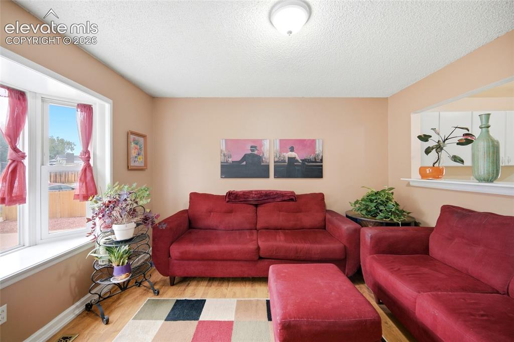 Image 10 of 47: Big front Picture window with seat that floods this room with sunshine! Ope