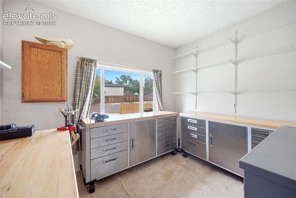 Image 19 of 47: At the front of the home ( converted garage) this space is being used as a 