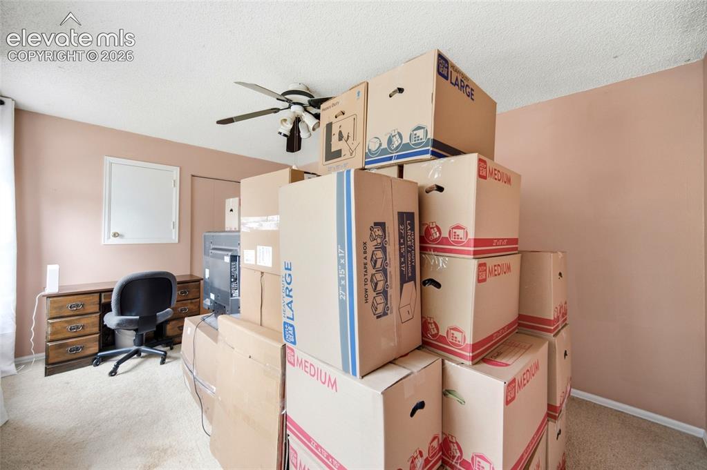 Image 30 of 47: Spacious upper-level bedroom with celling fan. 