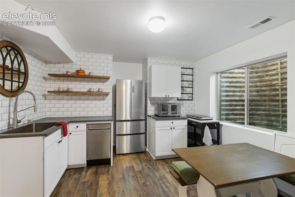 Image 23 of 39: Additonal kitchen and dining area in basement