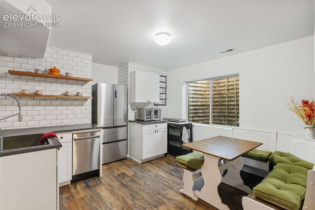 Image 24 of 39: Additonal kitchen and dining area in basement