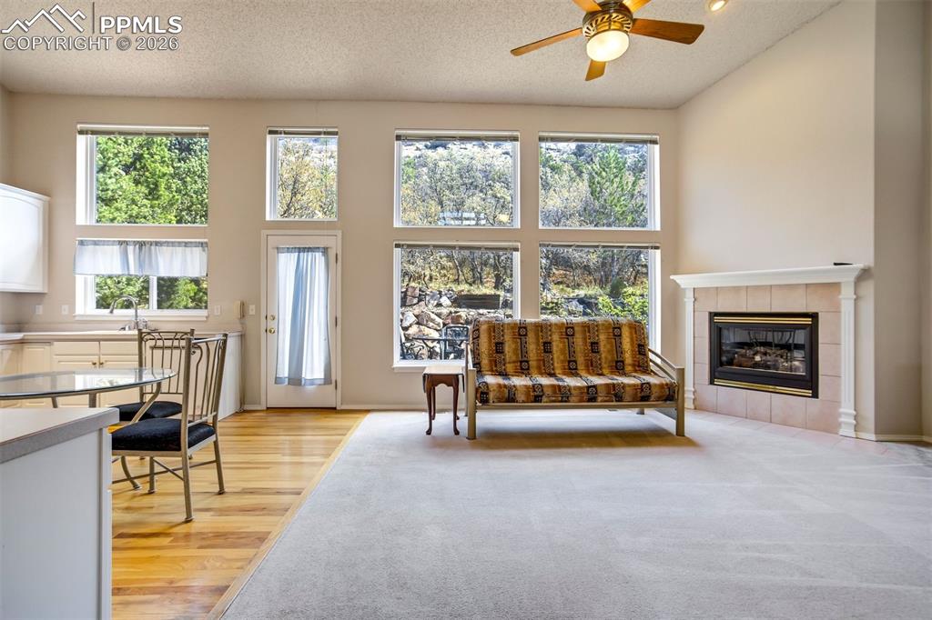 Image 11 of 44: Open concept living area featuring a vaulted ceiling with a ceiling fan, a 