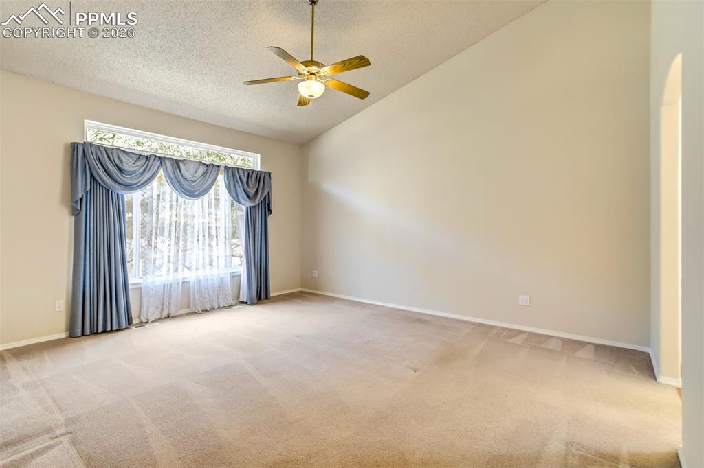 Image 17 of 44: Vaulted ceiling featuring a ceiling fan with integrated lighting