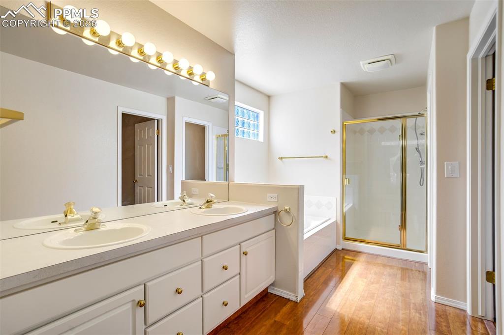 Image 19 of 44: Bathroom featuring a dual vanity with integrated sinks, a large mirror, and