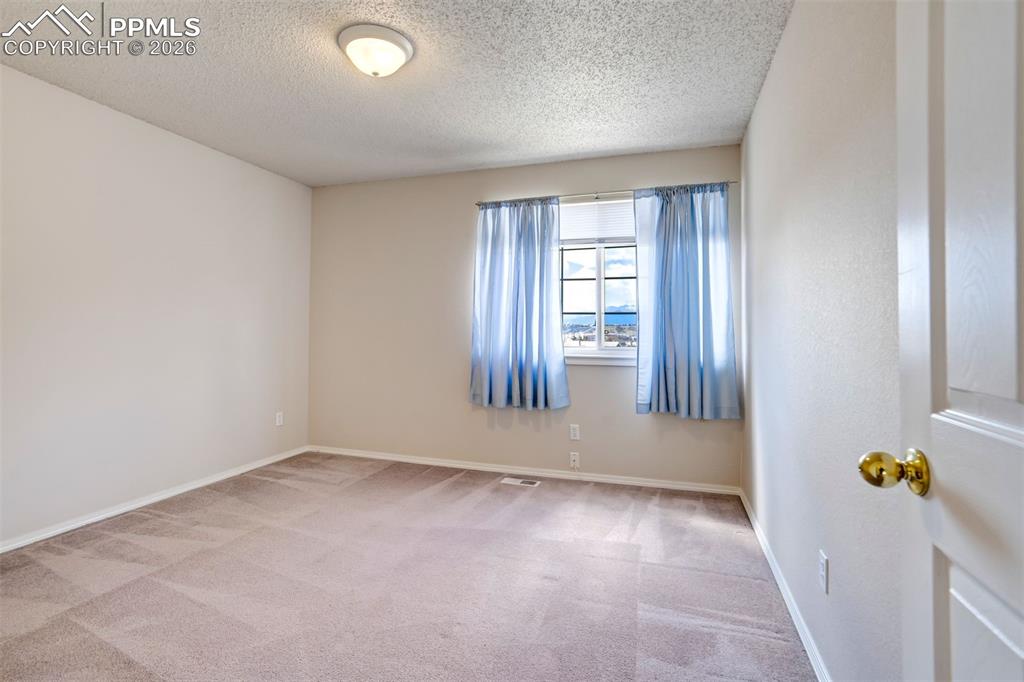 Image 22 of 44: Carpeted room featuring a window with exterior scenery, a flush-mount ceili
