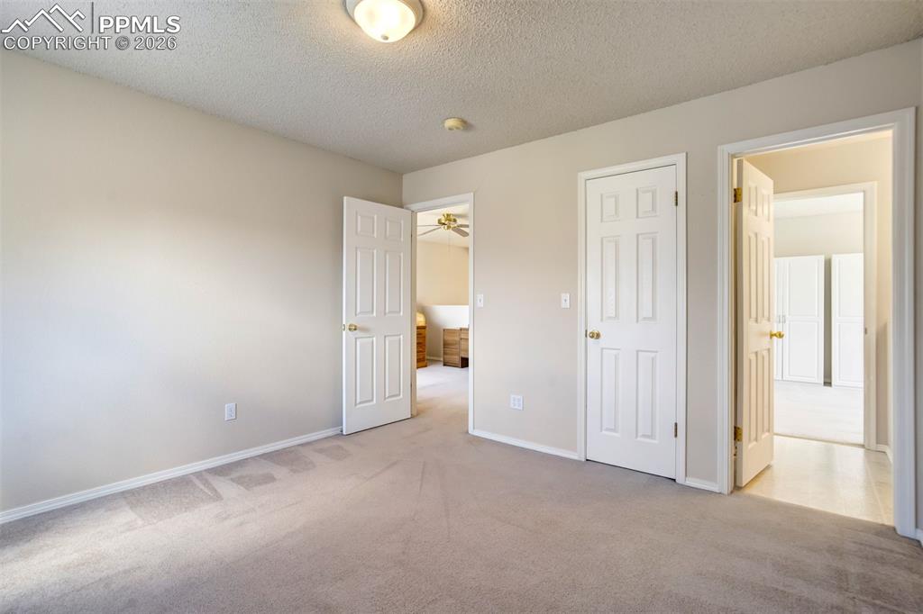 Image 23 of 44: Neutral-toned walls and plush carpeting throughout