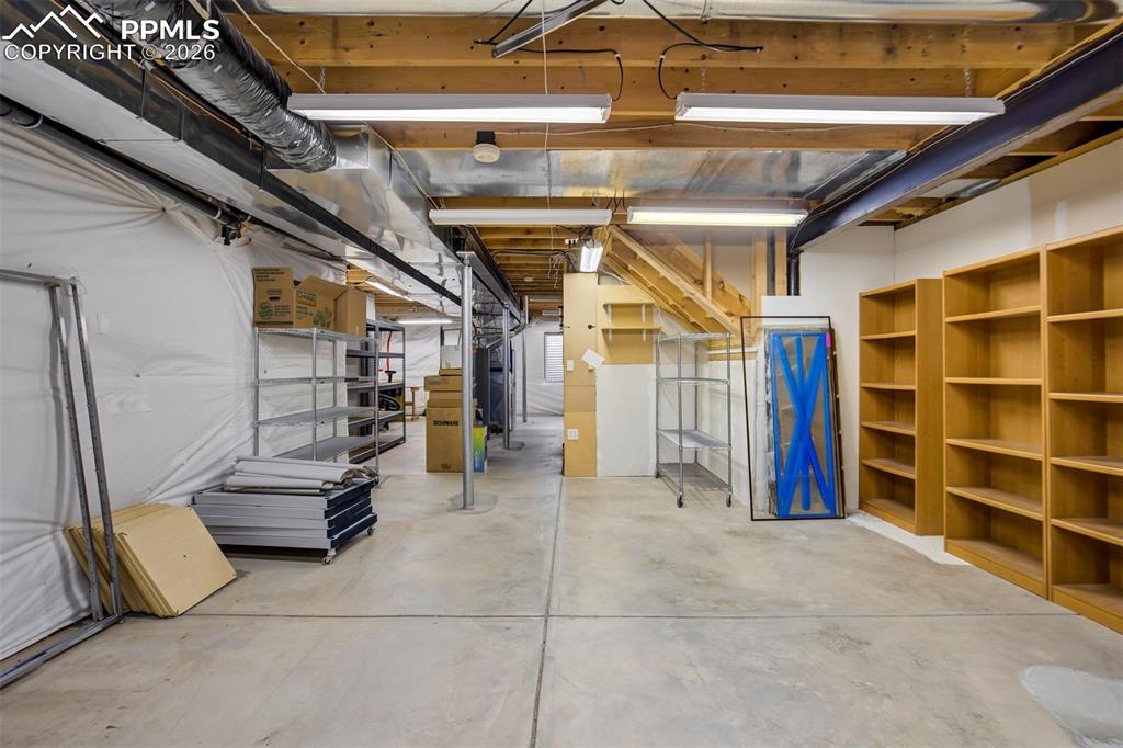 Image 37 of 44: Expansive unfinished lbasement featuring exposed wood beam ceiling, concret