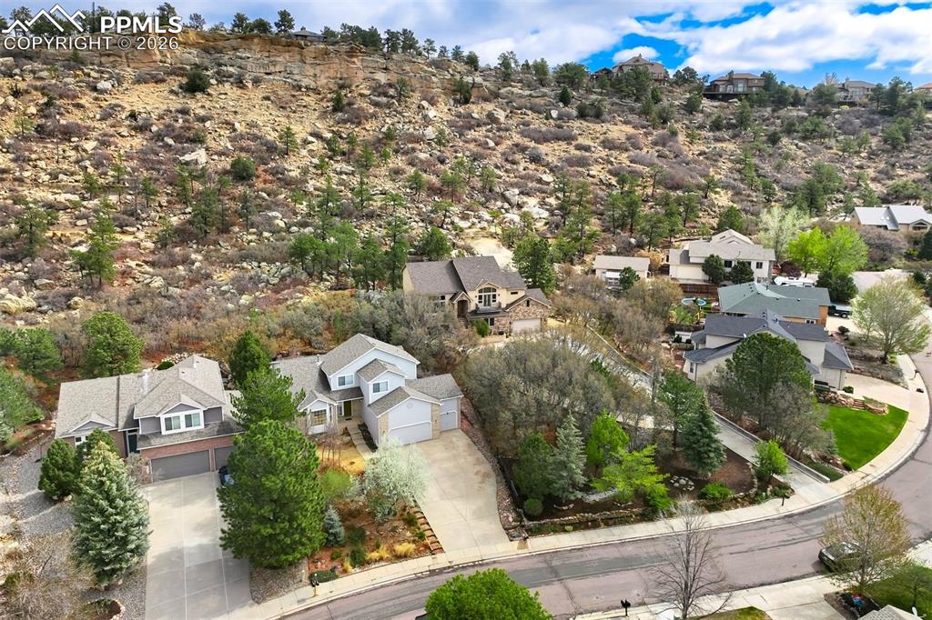 Image 39 of 44: Hillside community featuring natural rock formations and abundant evergreen