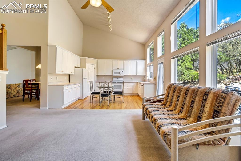 Image 7 of 44: Vaulted ceiling interior featuring expansive floor-to-ceiling windows, ligh