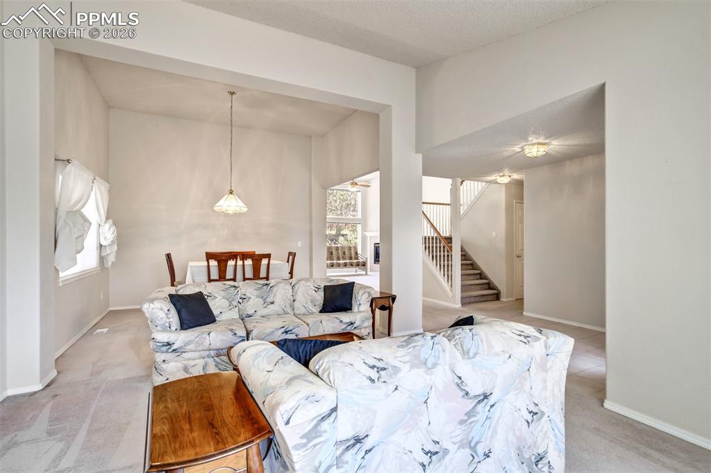 Image 8 of 44: Open-concept living space featuring high ceilings, neutral wall tones, and 