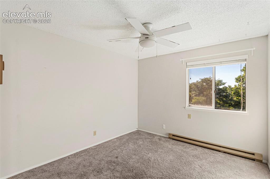 Image 15 of 18: Room featuring neutral wall finishes, textured ceiling, gray carpeting, and