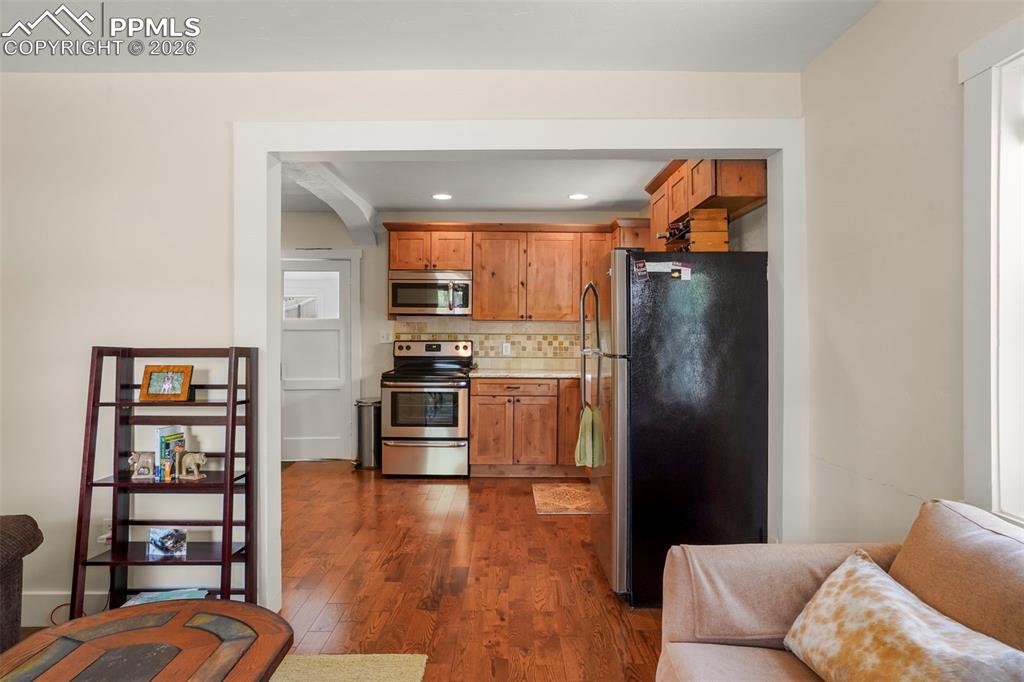 Image 6 of 29: Open floor plan to kitchen and dining area.