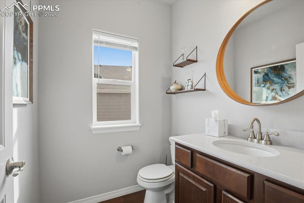 Image 17 of 40: Main floor bathroom with updated vanity and modern lighting