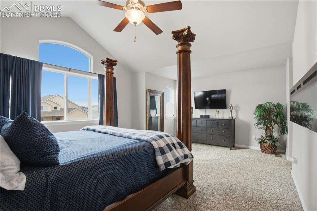 Image 5 of 40: Spacious primary bedroom retreat with large windows, ceiling fan, and peace