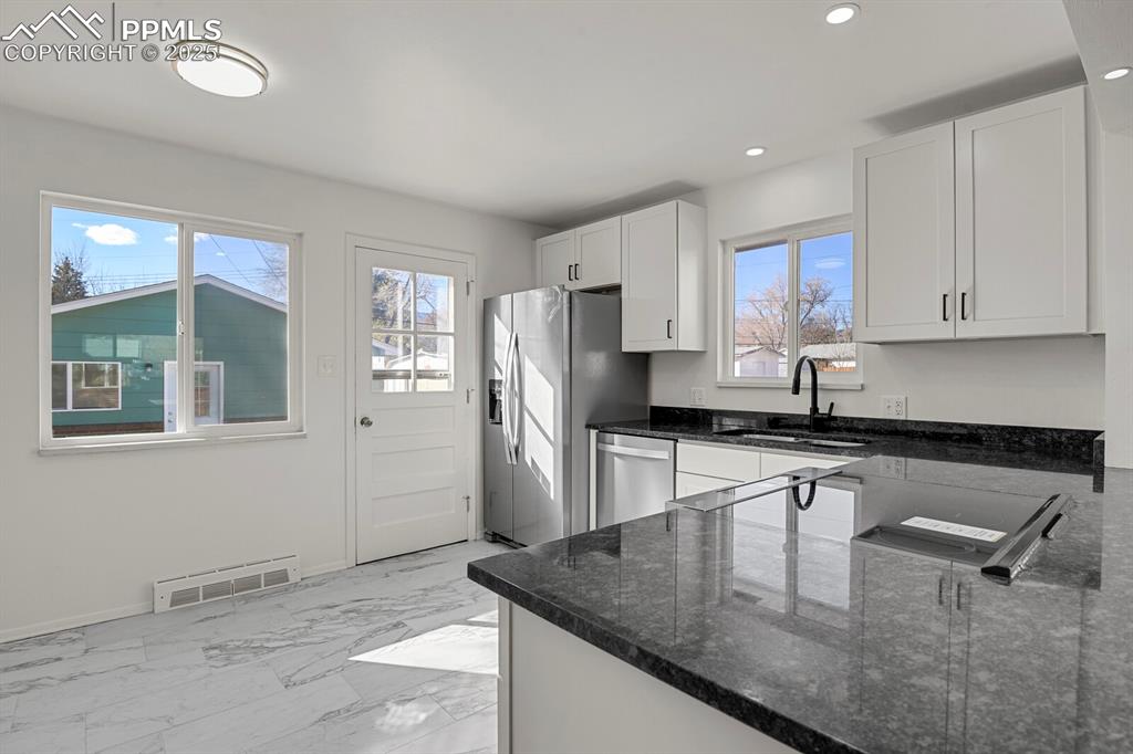 Image 12 of 37: Granite countertops and custom ceramic tile