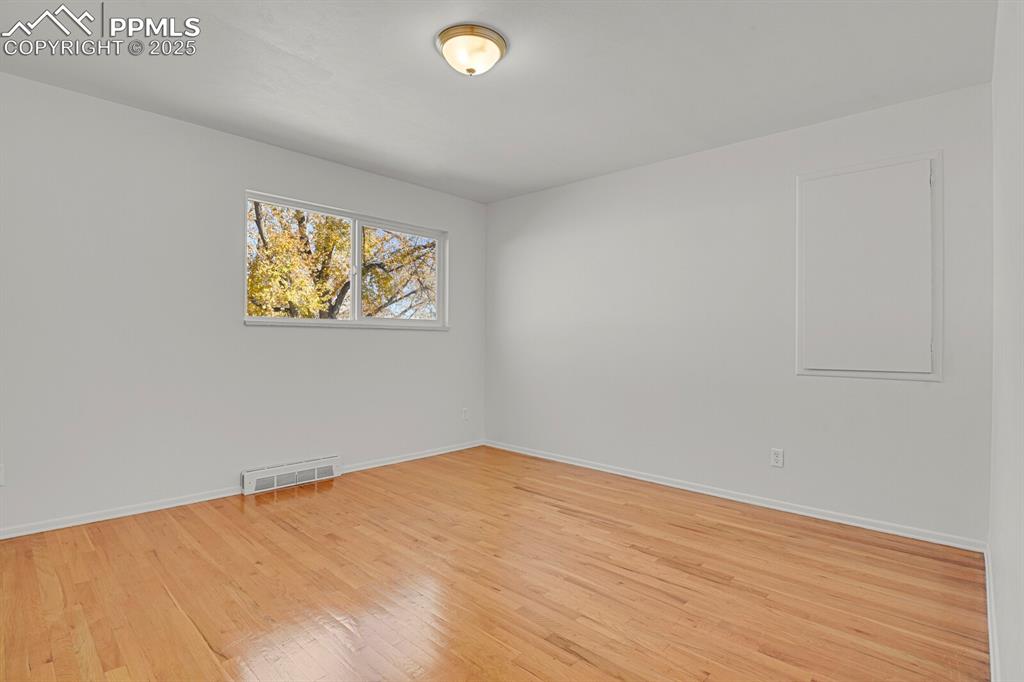 Image 15 of 37: Primary Bedroom with hardwood floors