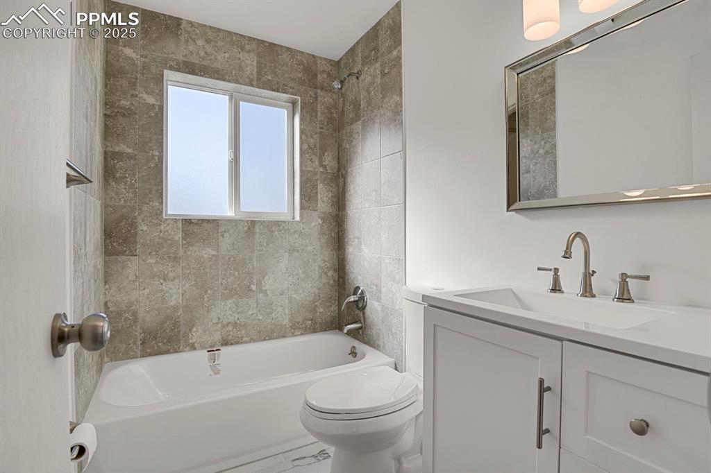 Image 17 of 37: Updated primary bathroom with new fixtures and ceramic tile
