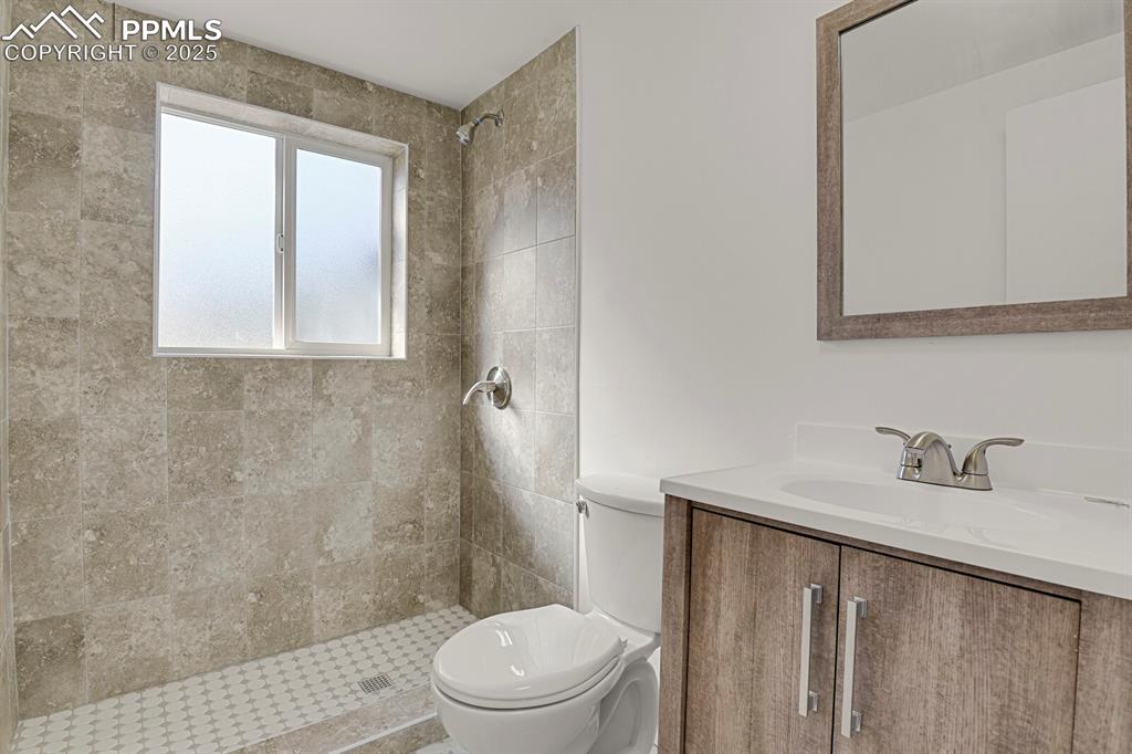 Image 24 of 37: Lower level 3/4 bathroom with newer fixtures, new shower tile and valves