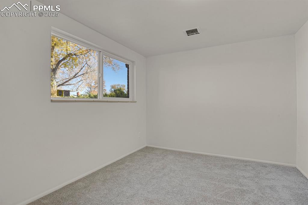 Image 25 of 37: Lower level bedroom with walk in closet