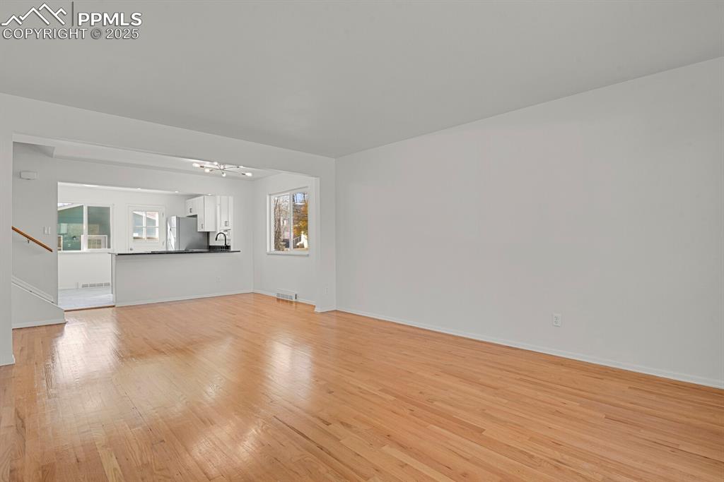 Image 4 of 37: Living Room with real hardwood and open design to kitchen